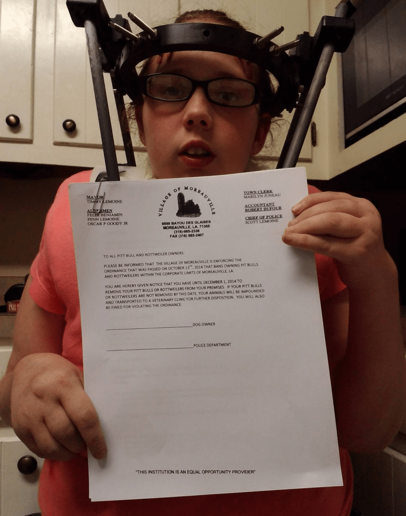 Zeus's owner holding up the demand letter she received from Moreauville.